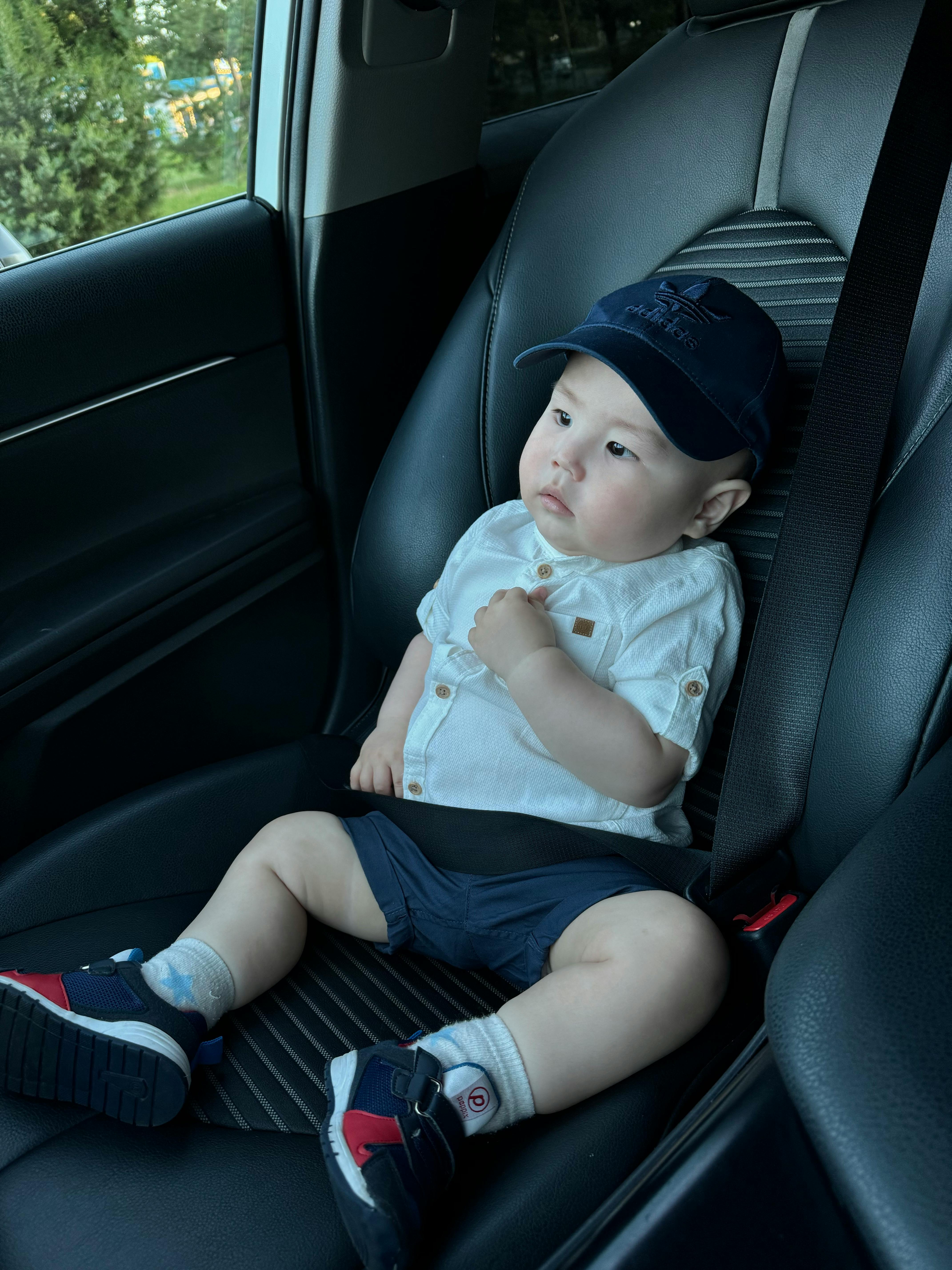 Adorable toddler securely sitting in a car seat ready for travel