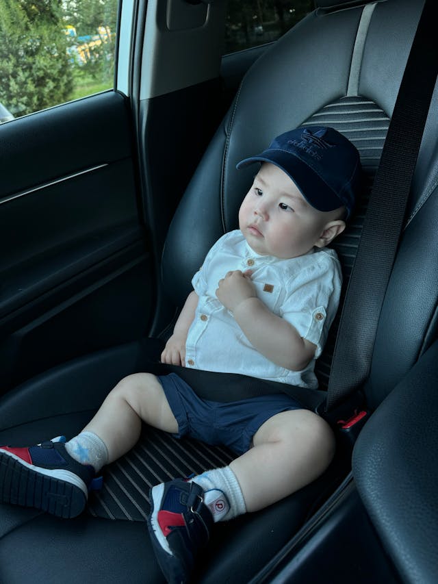 Toddler securely sitting in a car seat