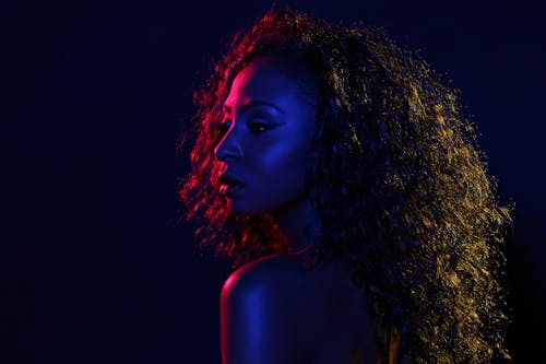 Portrait Photo of Woman in Blue and Red Light Background Posing