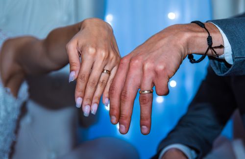 Free A couple showcasing their wedding rings at a ceremony, symbolizing love and commitment. Stock Photo