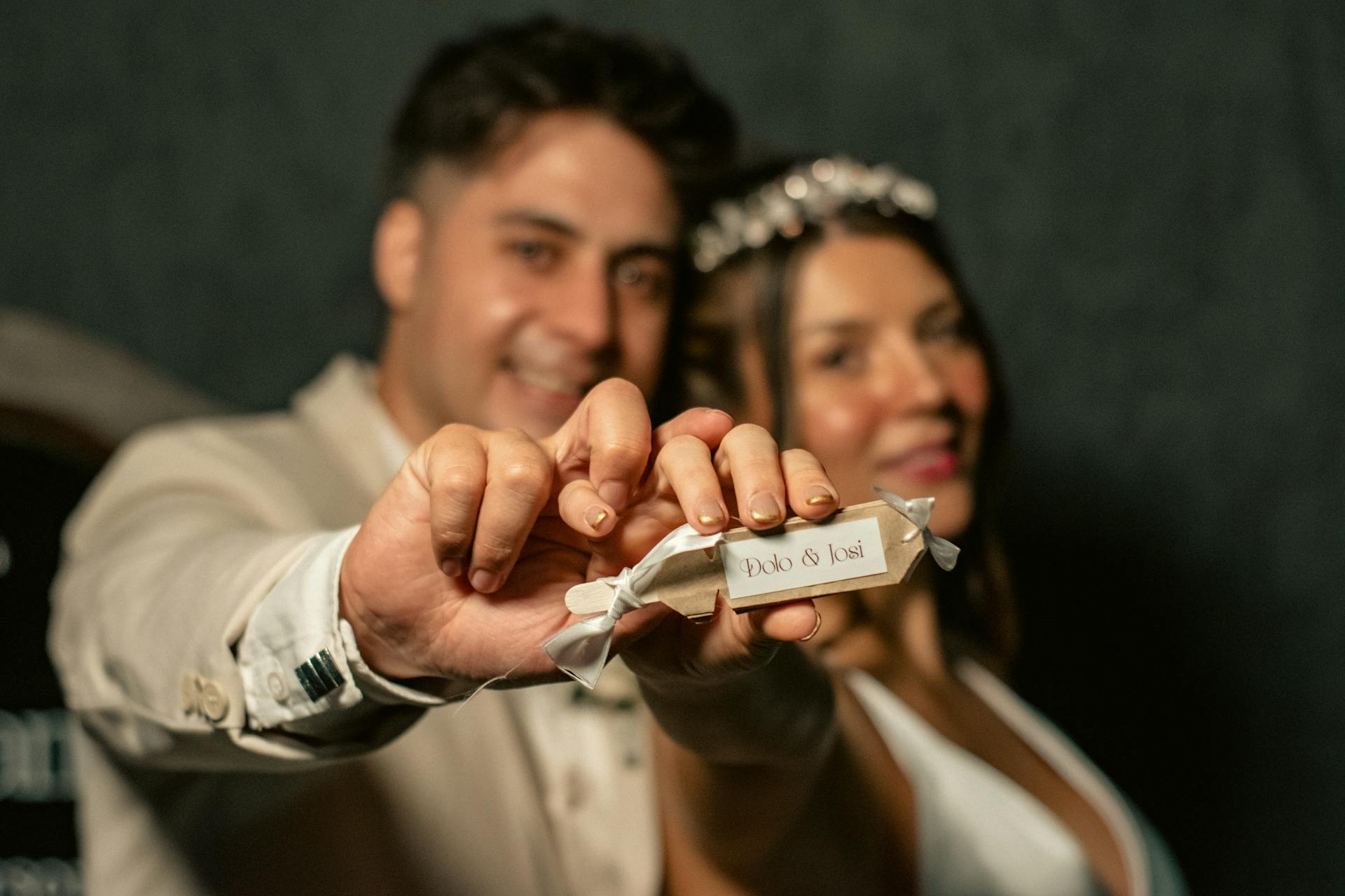 A joyful bride and groom hold their wedding favors, celebrating love and unity on their special day.