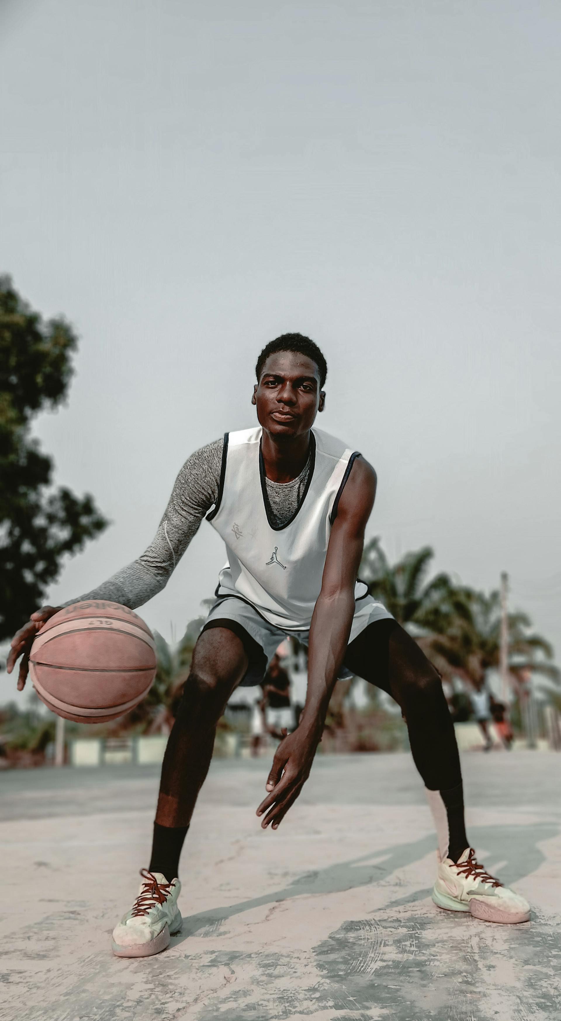 Basketball player on outdoor court in Moro, Nigeria