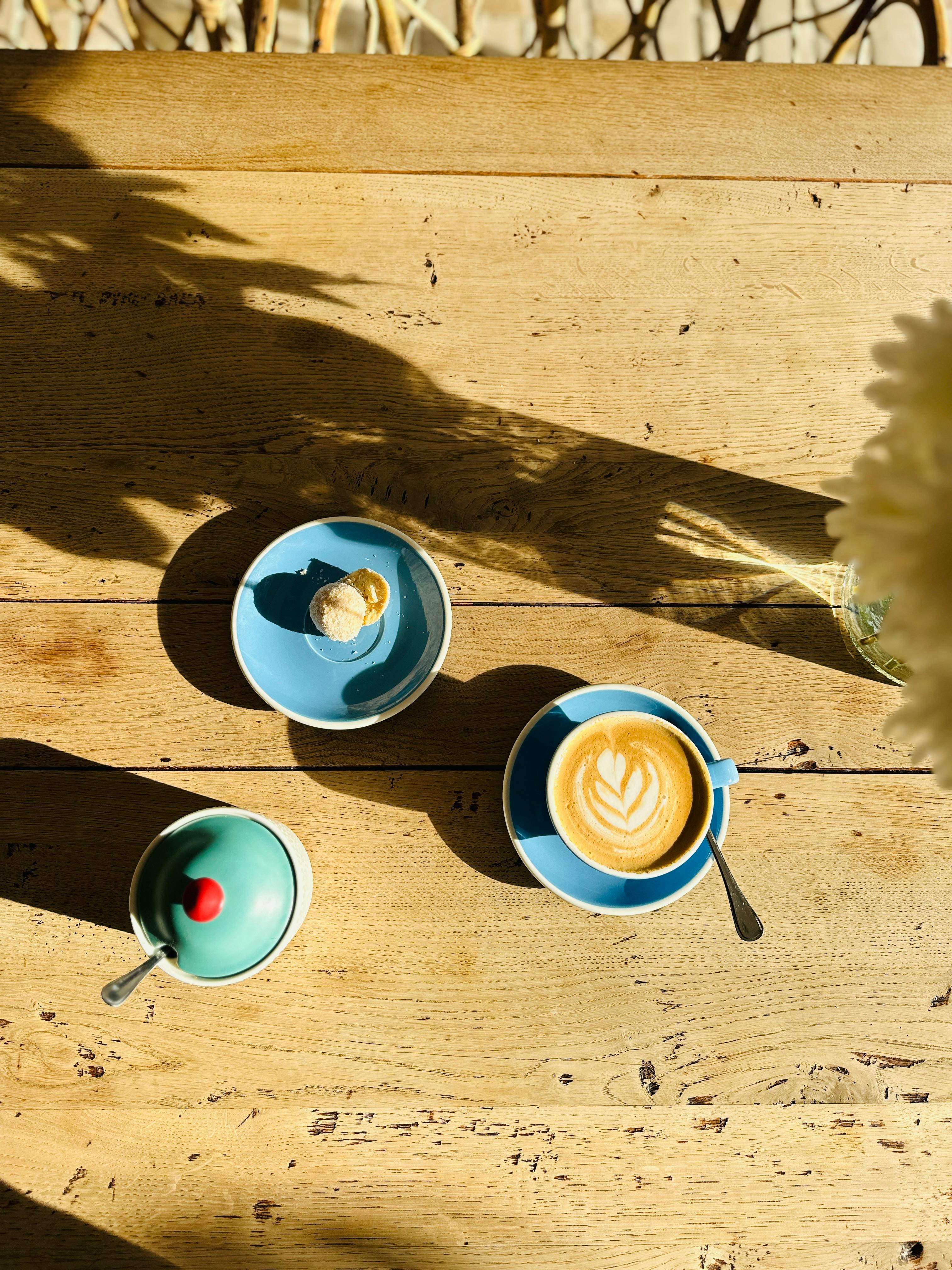 modern flat lay of latte with biscotti on wooden table