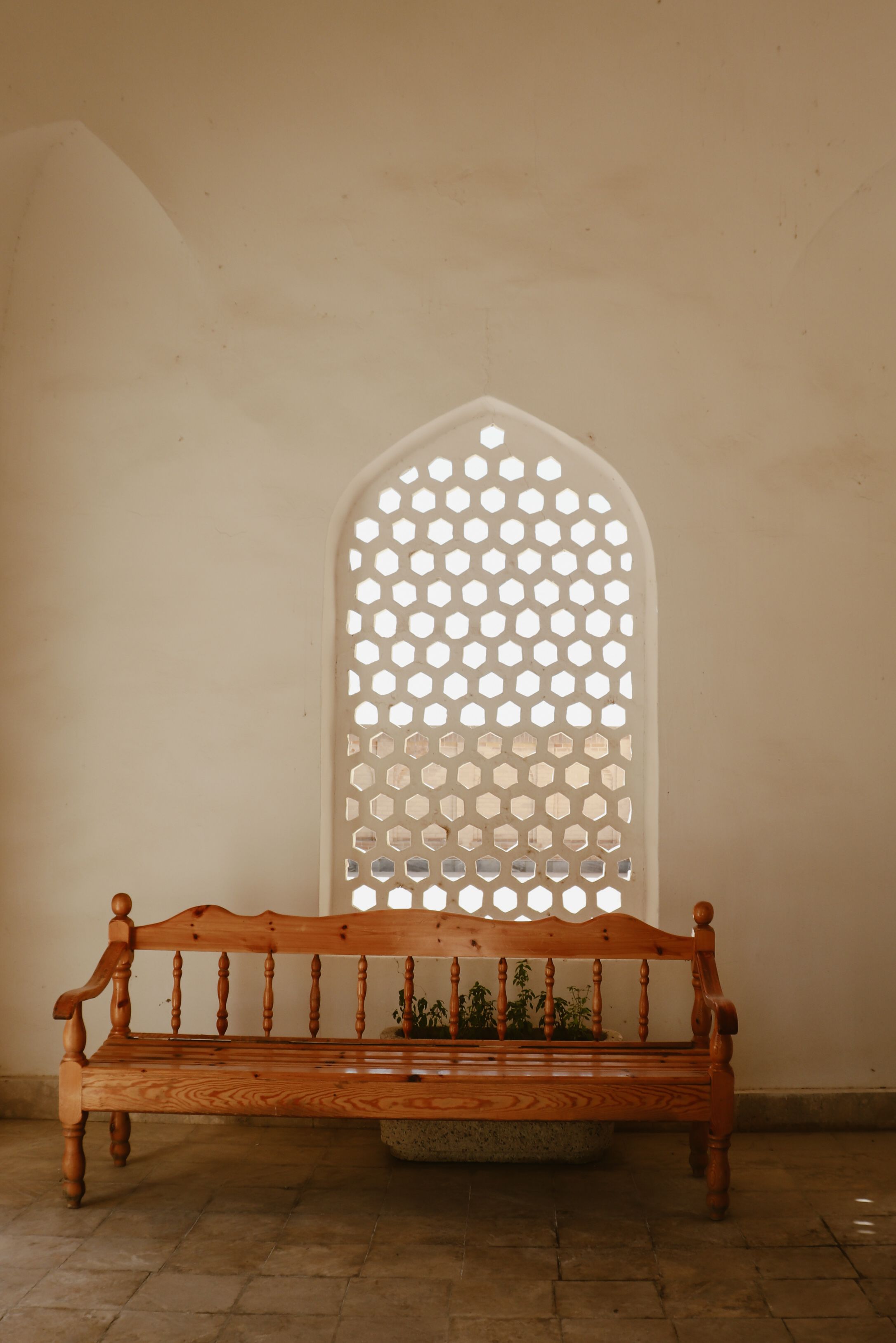 Rustic Wooden Bench Under Arched Window Indoors · Free Stock Photo