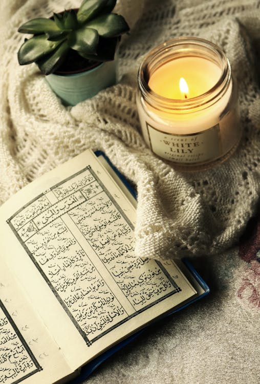 Free Photo Of Quran Beside Lighted Candle  Stock Photo