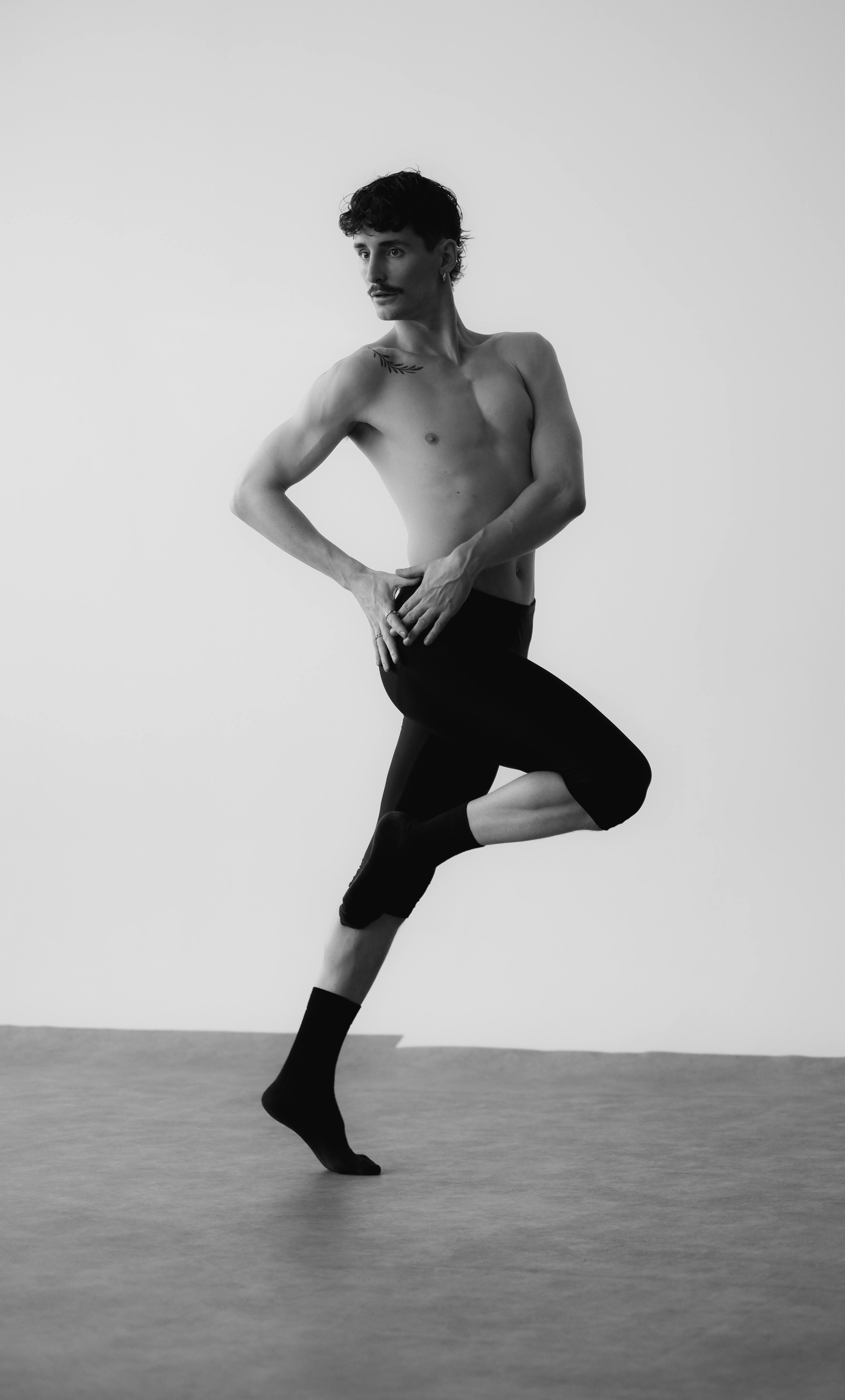 Monochromatic image of a male ballet dancer performing a graceful pose.