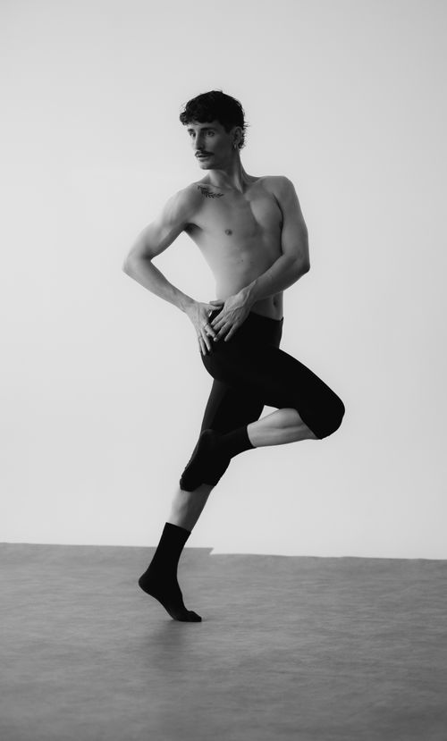 Free Monochromatic image of a male ballet dancer performing a graceful pose. Stock Photo