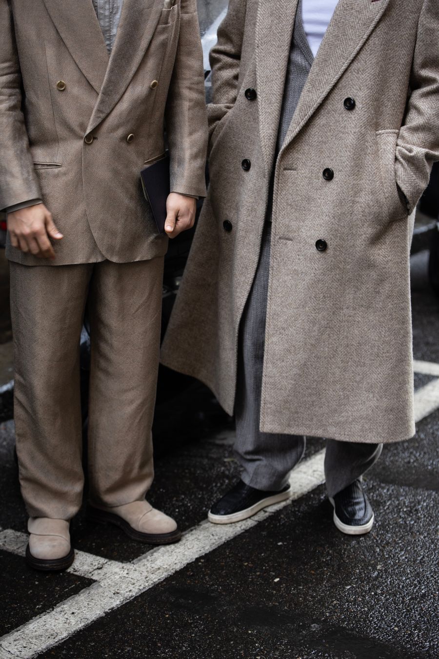 Two men in wool tailoring and herringbone overcoats, cropped below the shoulder — photo by Filip Rankovic Grobgaard on Pexels