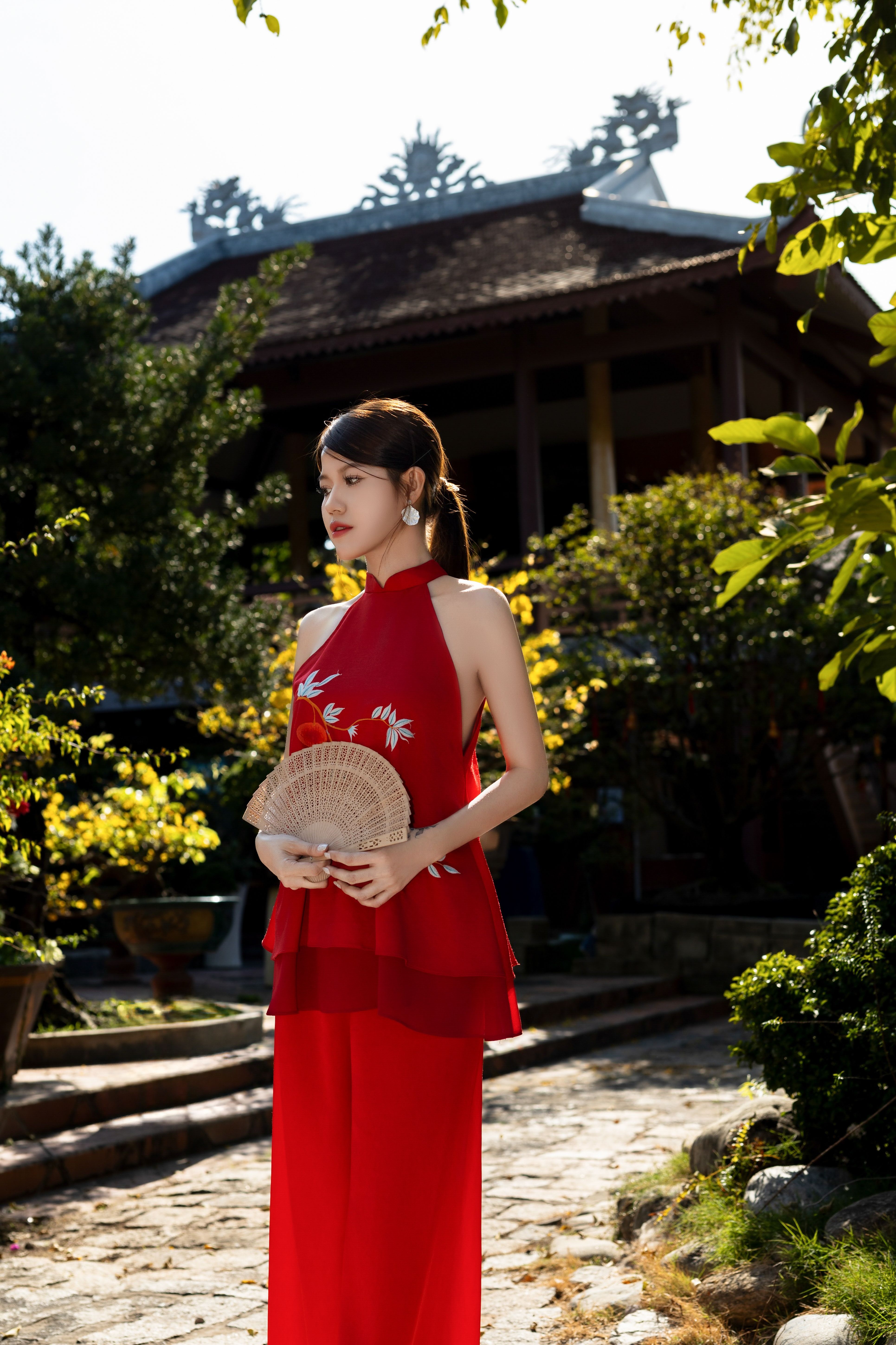 Woman in Traditional Red Dress Holding Fan Outdoors · Free Stock Photo