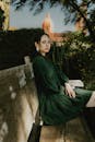 Elegant Woman in Green Dress on Park Bench