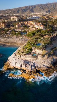 Stunning aerial shot of a luxurious resort on the rugged cliffs of Tenerife, Spain.