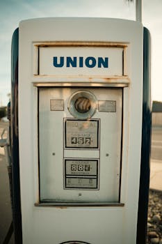 Close-up of a vintage Union gas pump with warm tones and rustic details at sunset.
