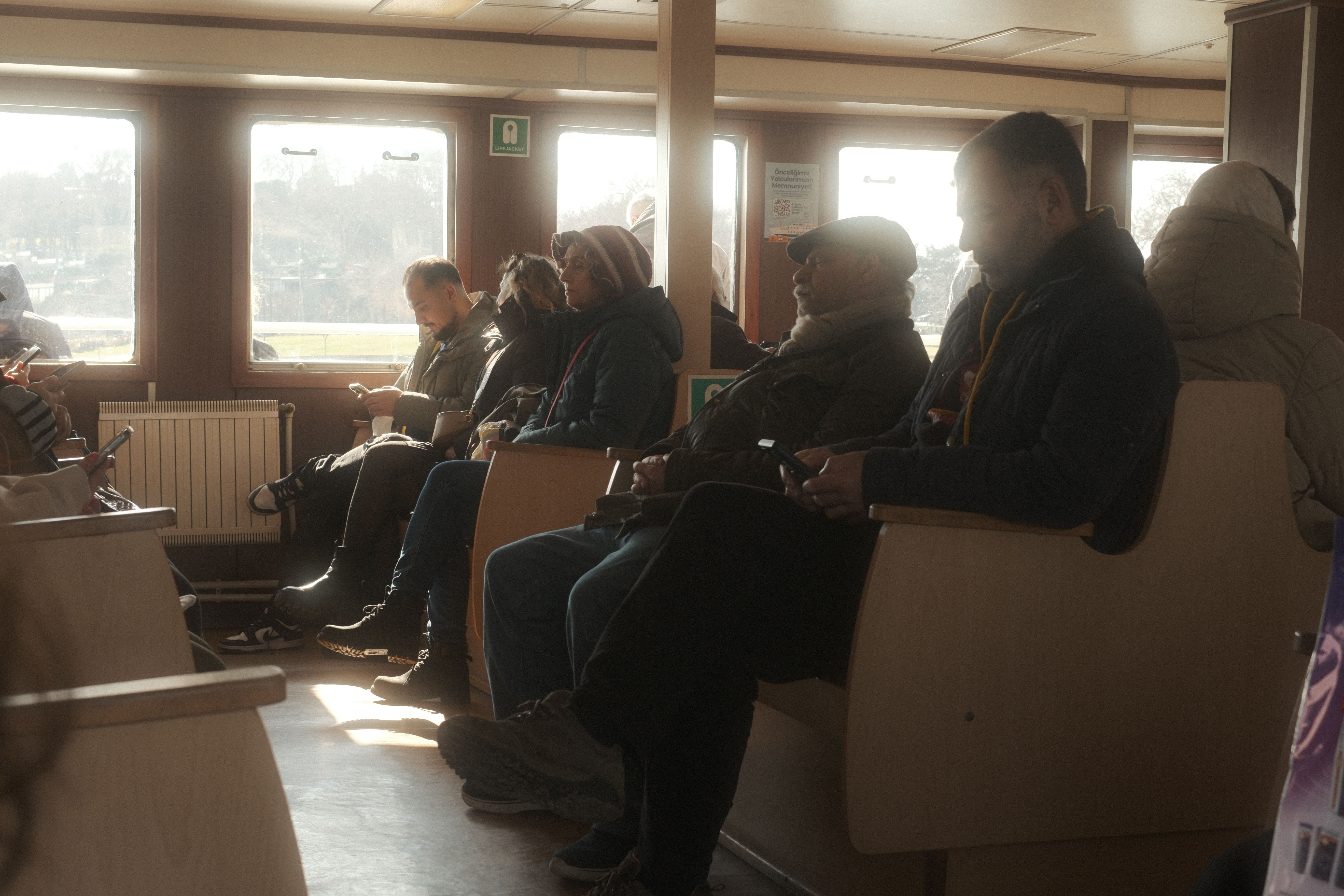 Commuters Relaxing on Istanbul Ferry Ride · Free Stock Photo