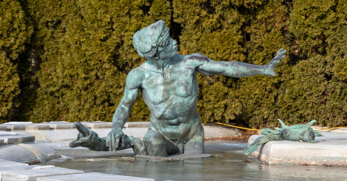 a sculpture of a person breaking out of a marble block, symbolizing breaking free from constraints