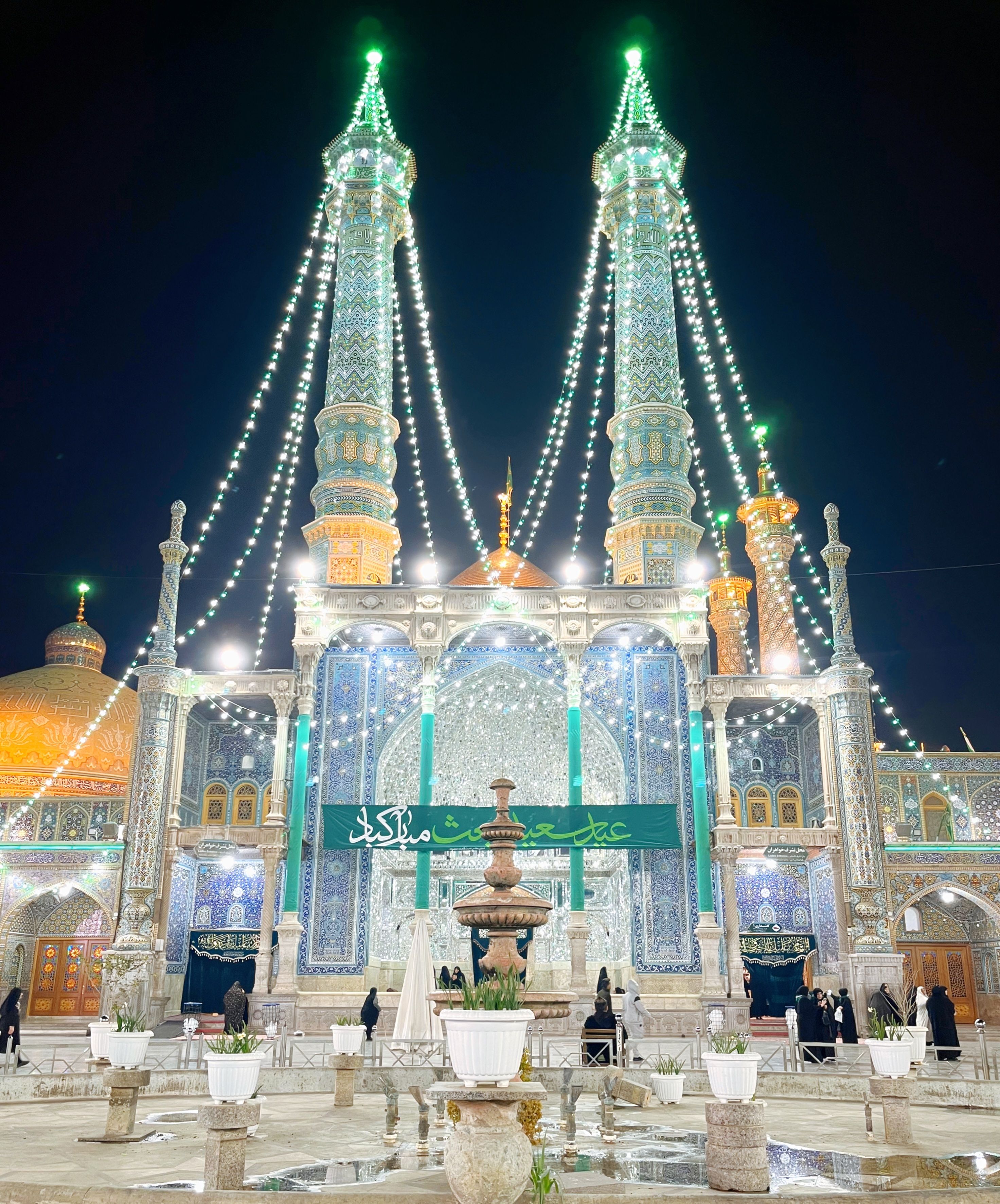 Stunning view of the shrine in Qom, Iran, beautifully illuminated against the night sky.