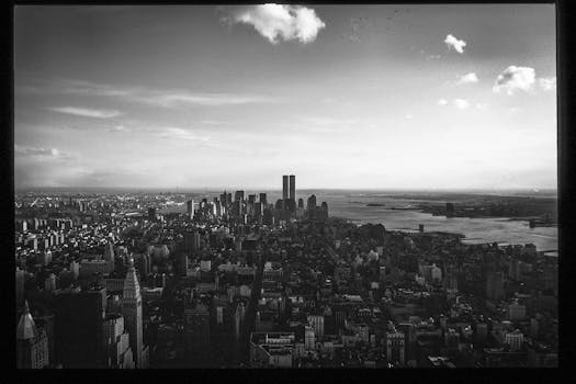 Black and white aerial image of Manhattan with the iconic Twin Towers.