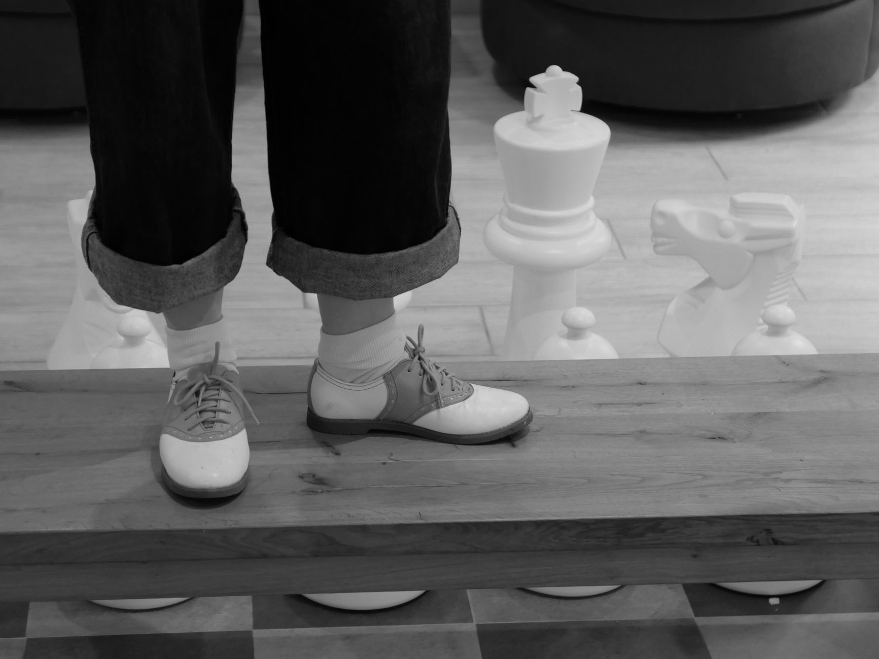 Black and white photo of retro saddle shoes on a giant chessboard. Gainesville, Florida.