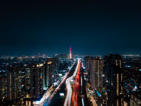 Beautiful night view of Ho Chi Minh City skyline with light trails and illuminated buildings.