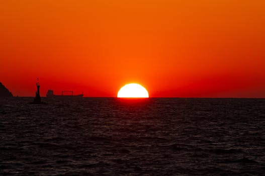 Beautiful sunset over Istanbul's coast with ship silhouettes.