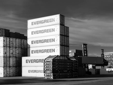 Black and white photo of stacked shipping containers at Hamburg port terminal.