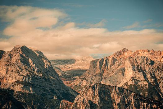 A breathtaking view of the mountains under a beautiful sky at sunrise, showcasing the serene landscape.