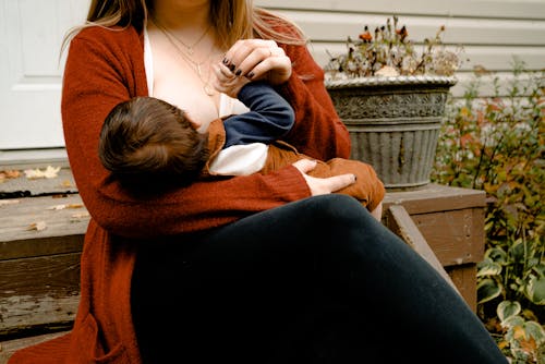 Photo Of Woman Breastfeeding Her Child