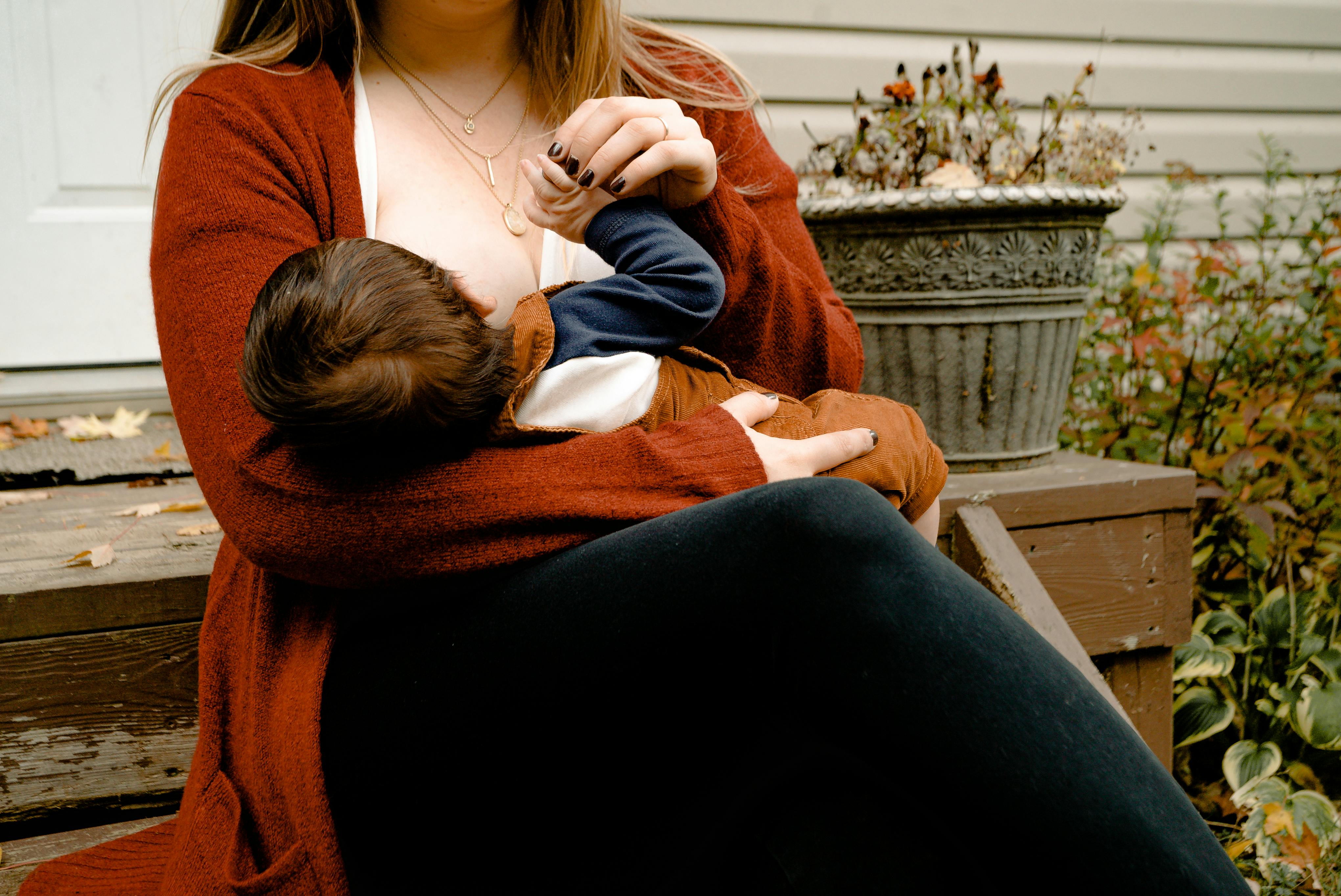 Young pregnant woman holding baby bottle hi-res stock photography