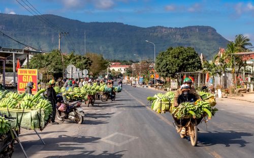 Free Local street market scene with banana vendors and motorbikes in Vietnam. Stock Photo