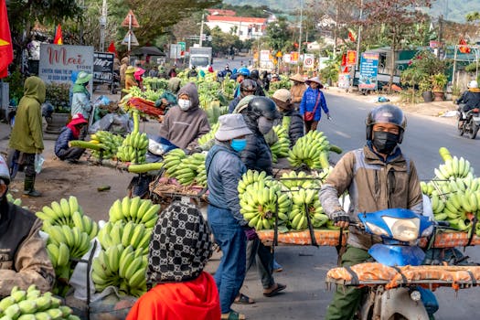 Vibrant market scene with vendors selling bananas on a busy street.