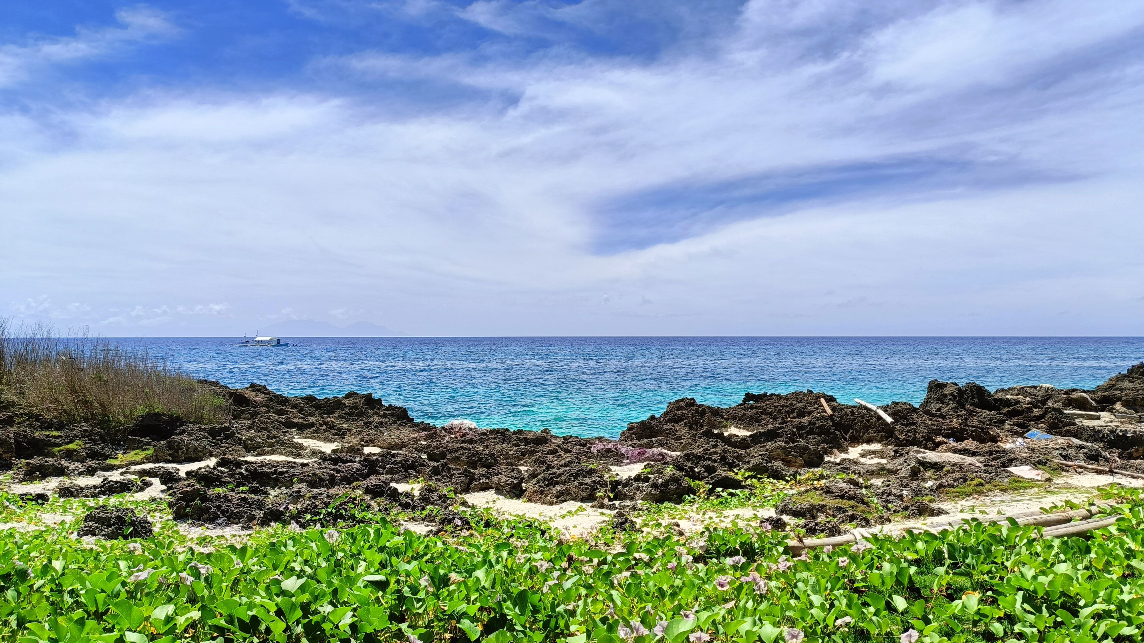Beautiful Rocky Beach with Clear Blue Ocean · Free Stock Photo