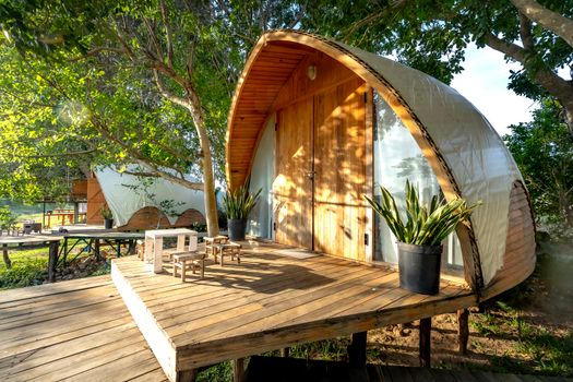 Charming wooden cabin with deck, nestled in forest, perfect nature retreat.