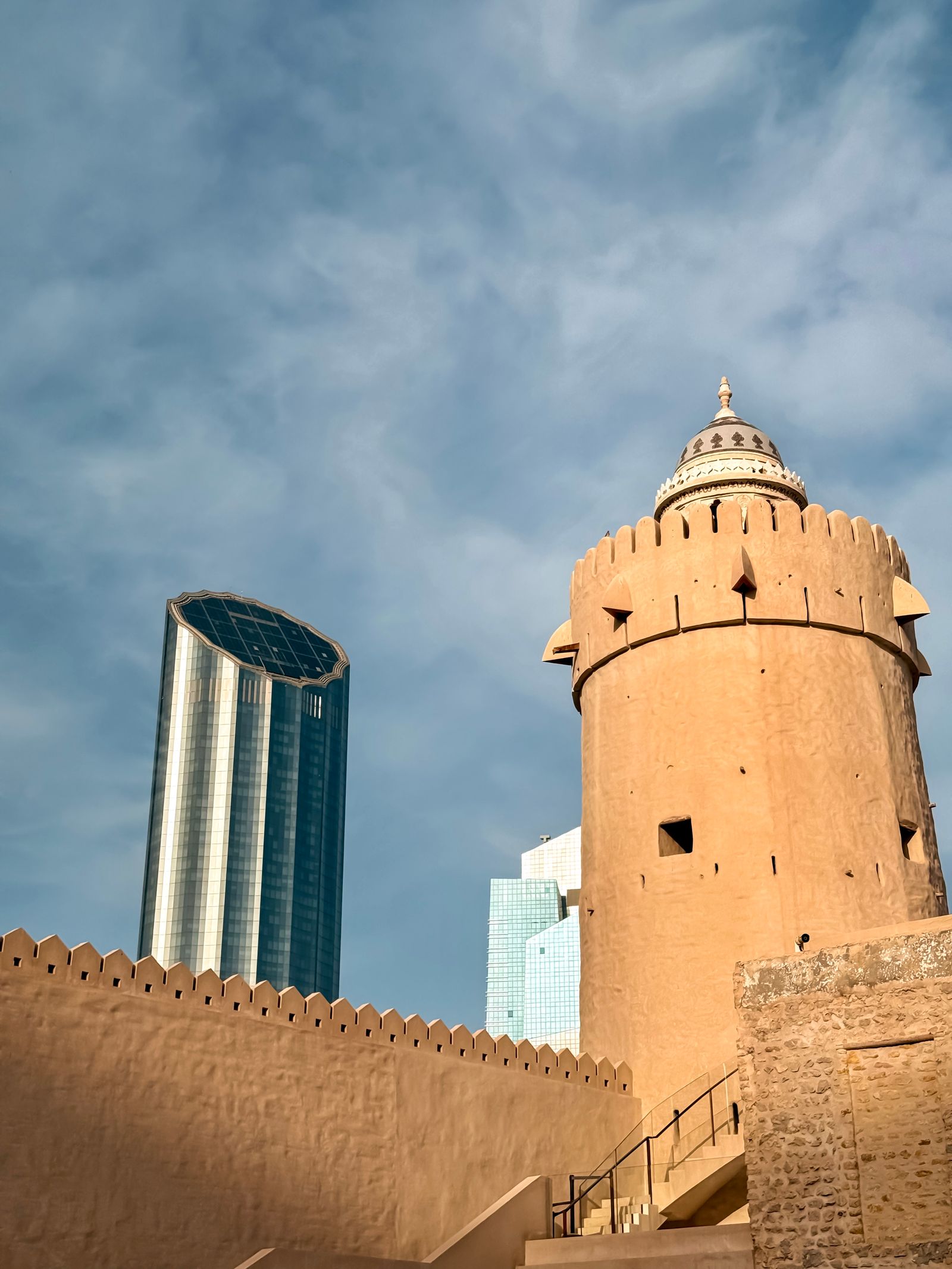 Qasr Al Hosn watchtower in front of modern towers