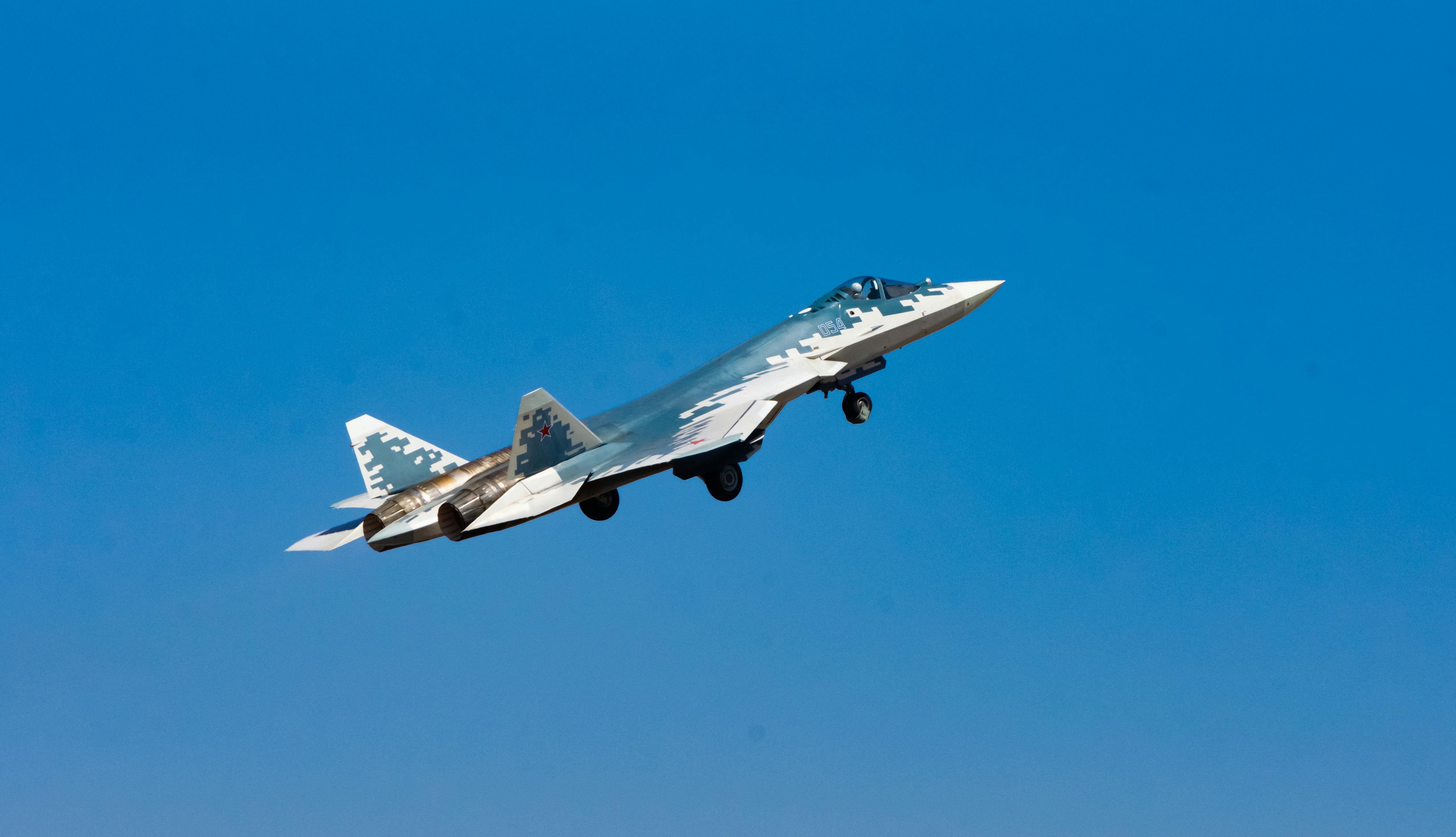 High-speed military jet aircraft soaring through the clear blue sky in Bengaluru.
