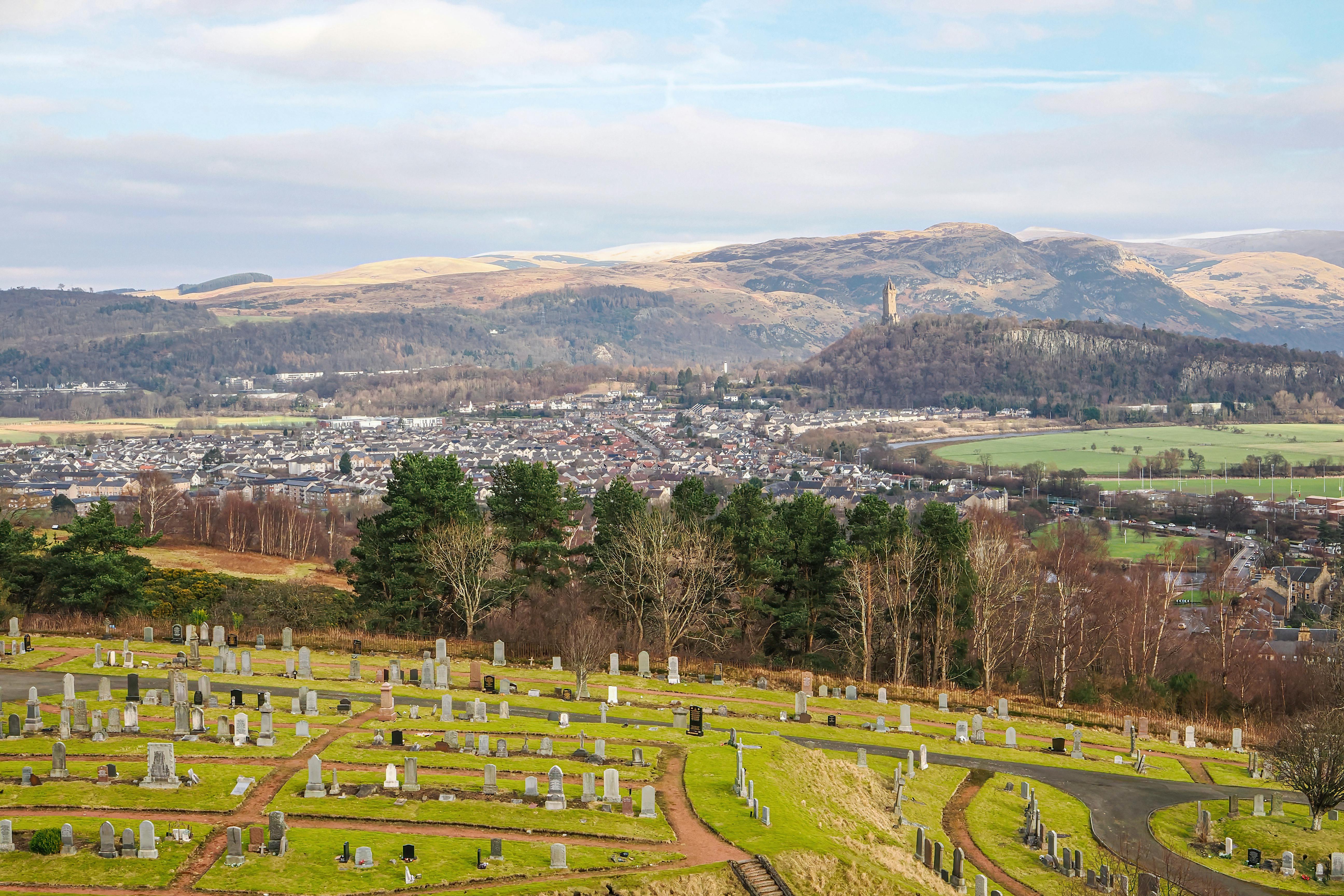 A picturesque view of Wallace Monument in Stirling, Scotland from a local cemetery.