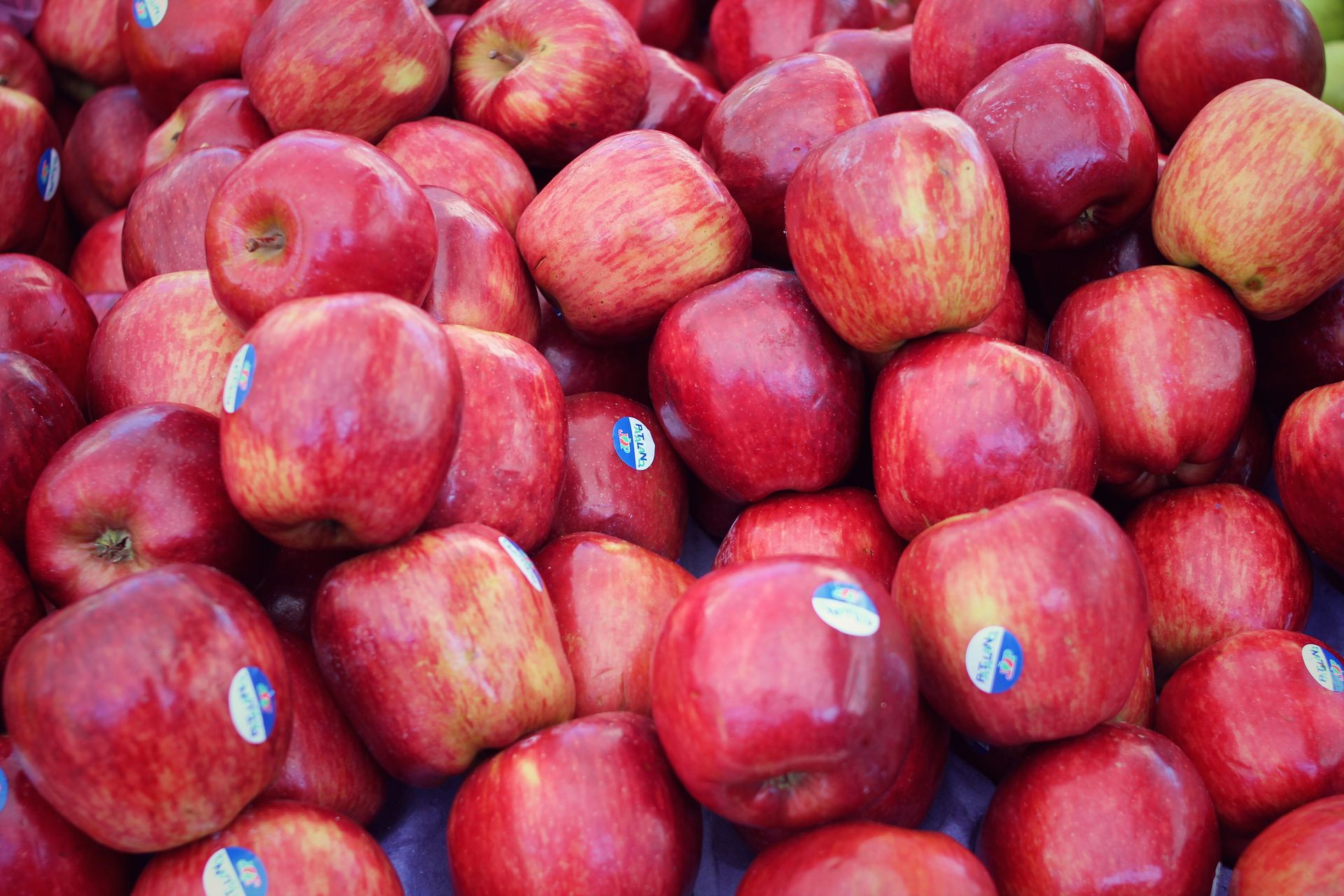A vibrant display of fresh red apples at a São Paulo market stall.