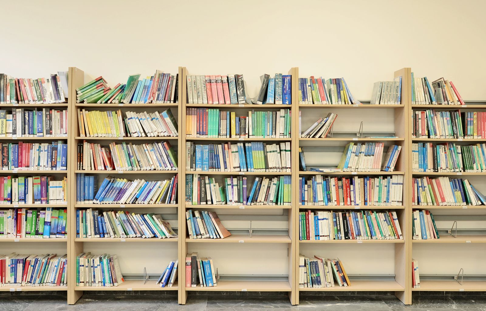 Library shelves filled with colourful book spines — photo by Moussa Idrissi on Pexels