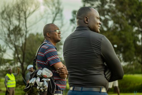 Free Two men at a golf course in Nairobi enjoying outdoor leisure. Stock Photo