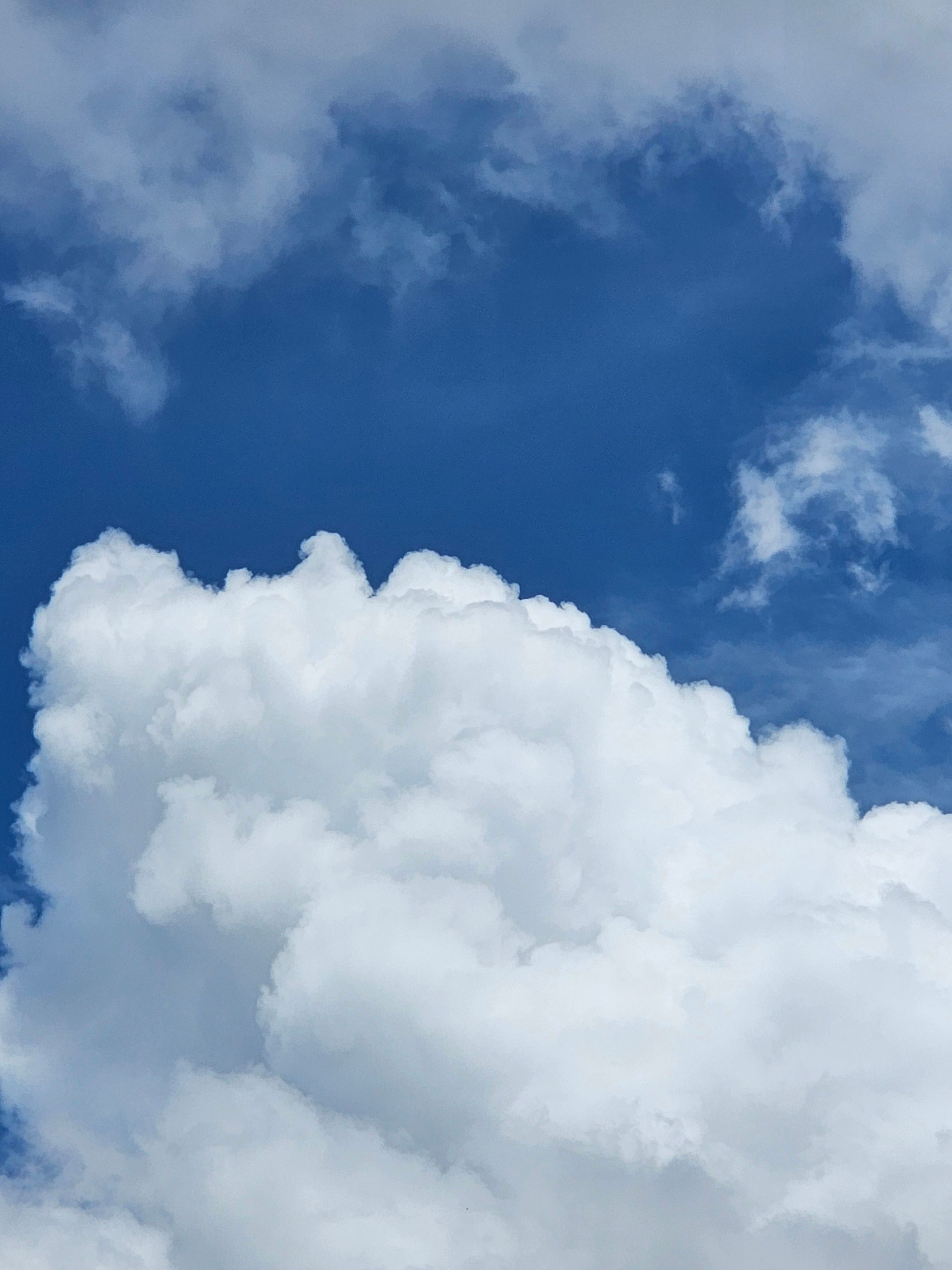 Fluffy White Clouds Against Blue Sky · Free Stock Photo