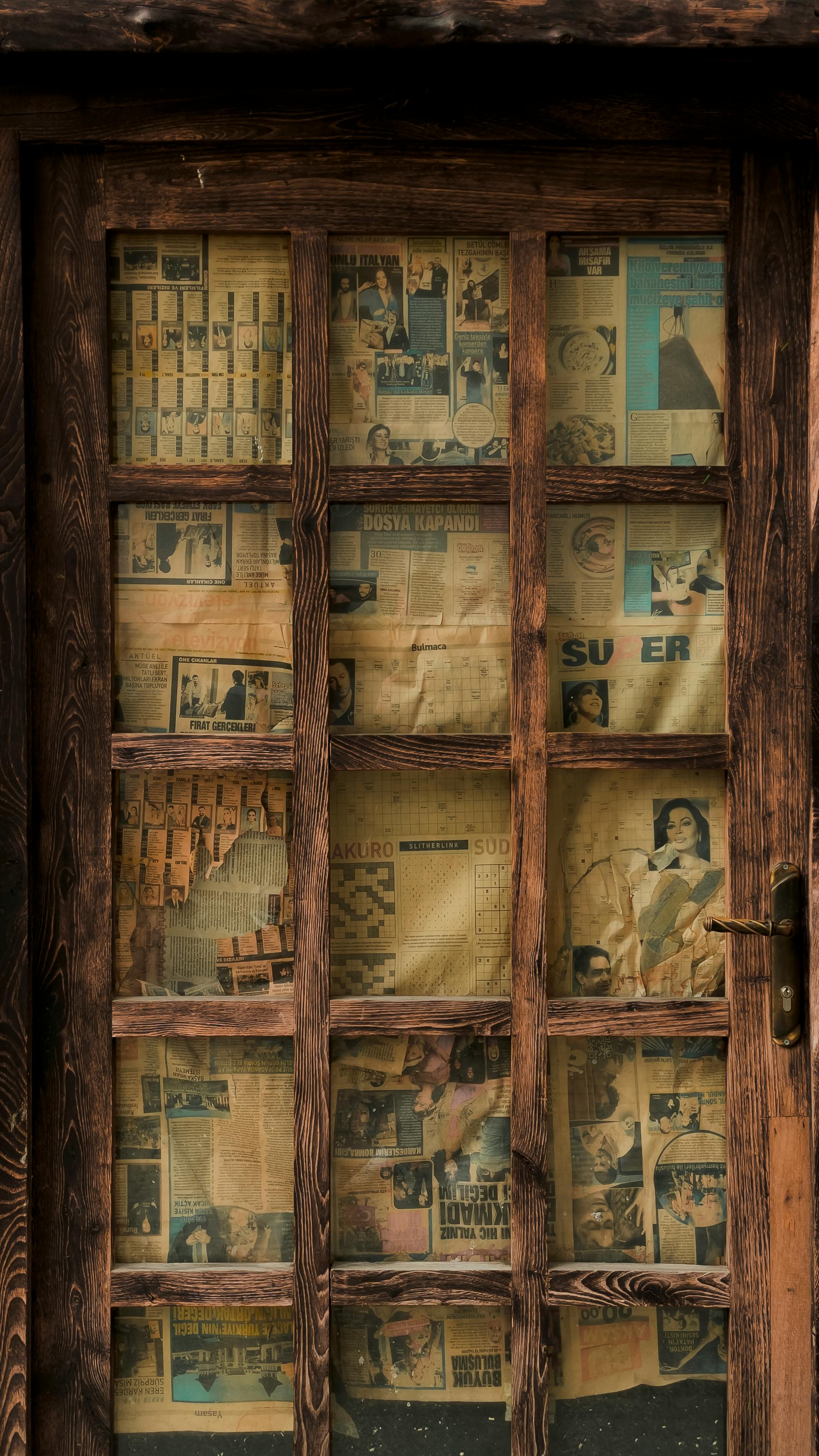 vintage wooden door with newspaper panels in artvin