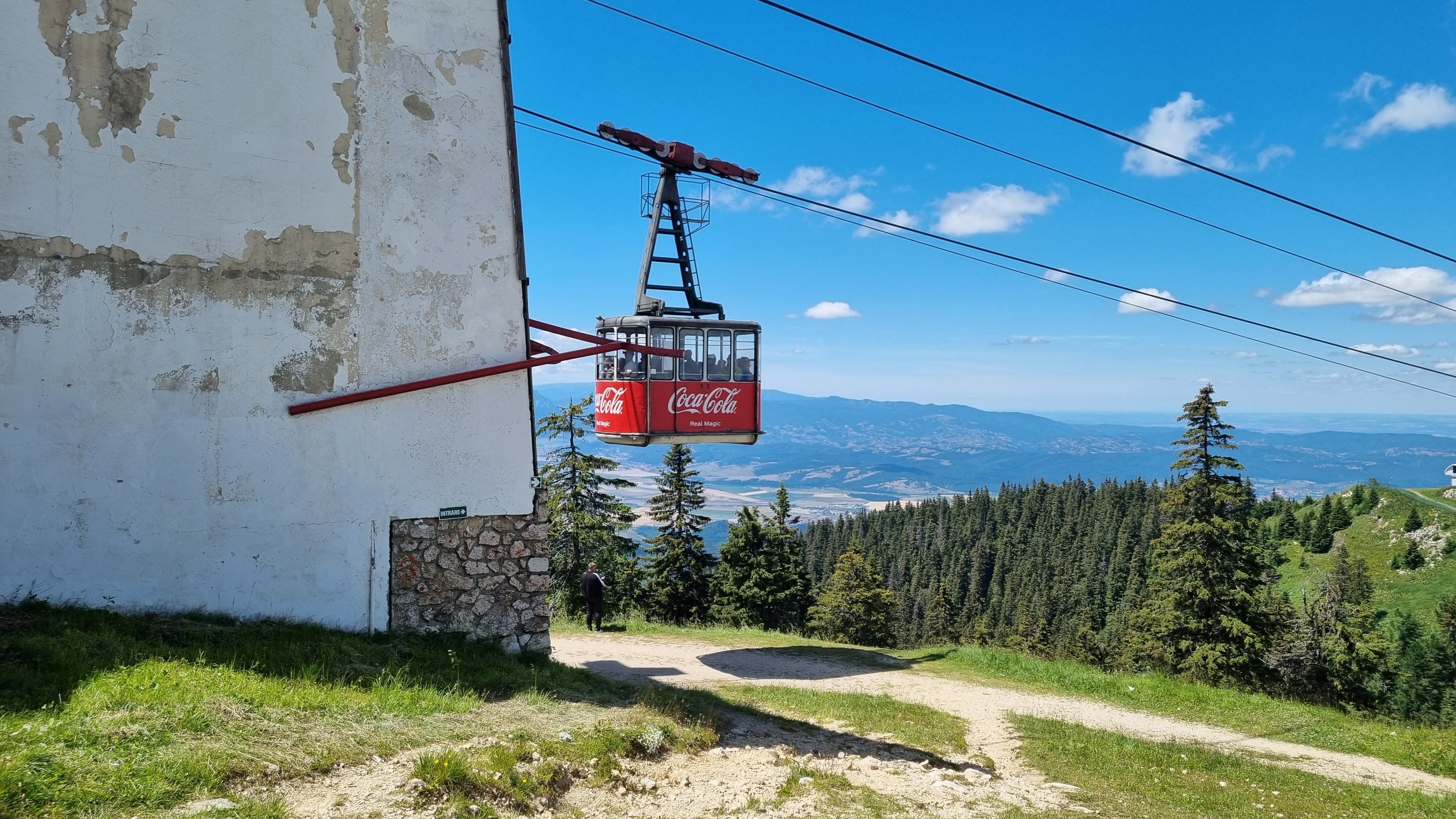 Tâmpa Mountain cable car ascending at golden hour in Brașov Romania with Carpathian peaks and historic city below