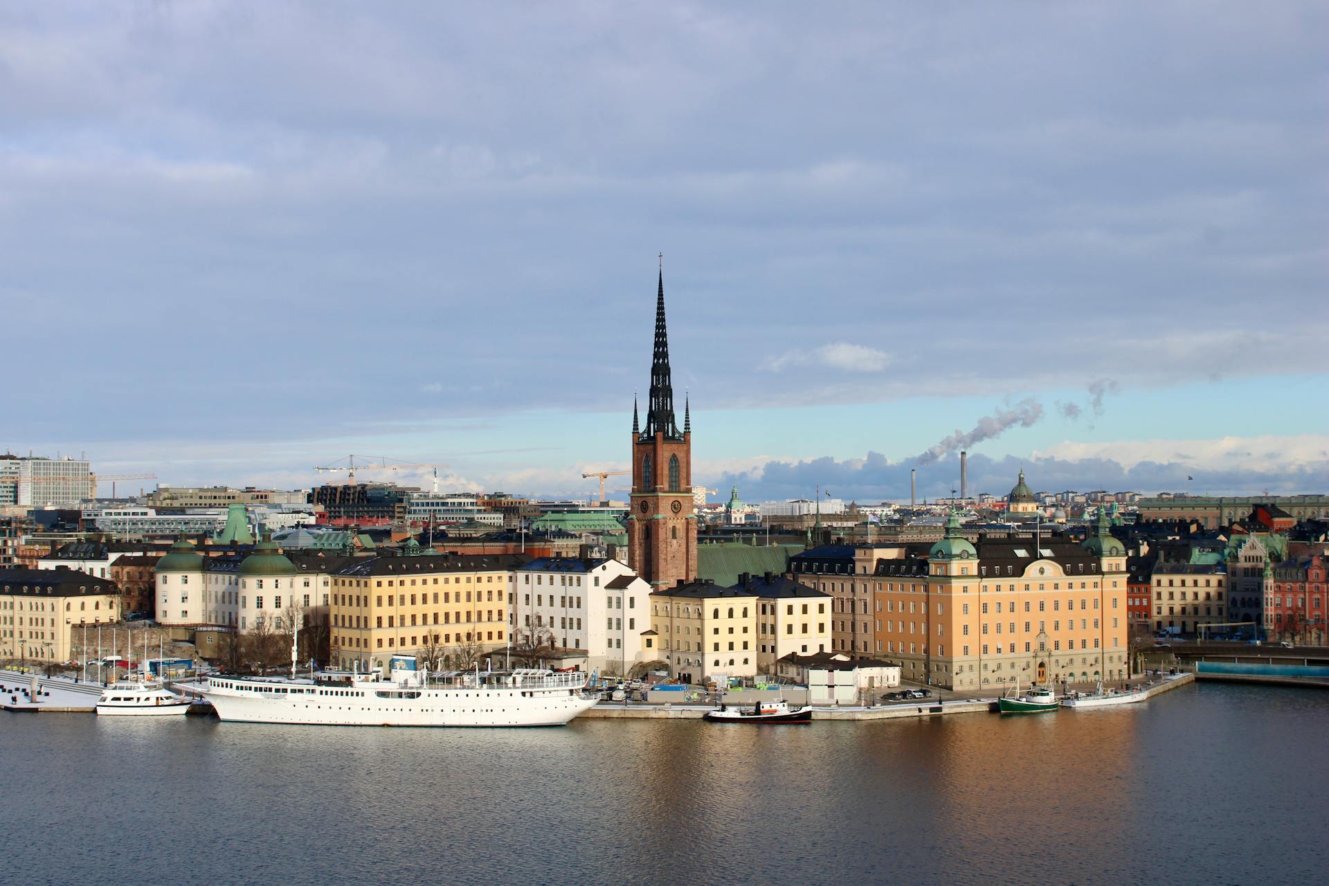 Scenic view of Riddarholmen Church and surrounding buildings by the Stockholm waterfront.