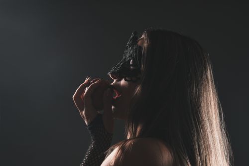 Free Artistic profile of a woman in a lace mask exploring sensuality. Stock Photo