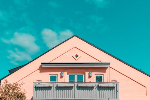 Pink and Gray House Under Blue Sky