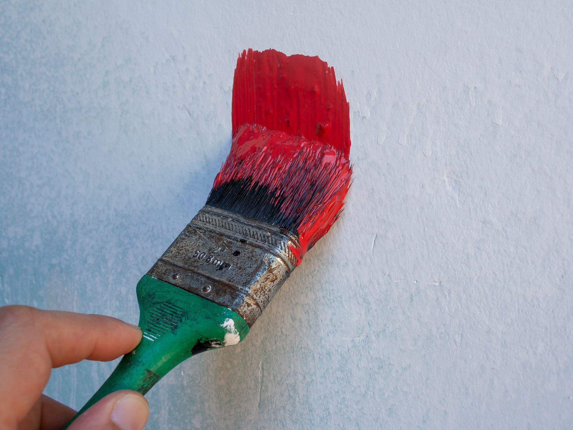 Painters & Decorators in Finsbury, London — professional decorator painting a wall with a roller
