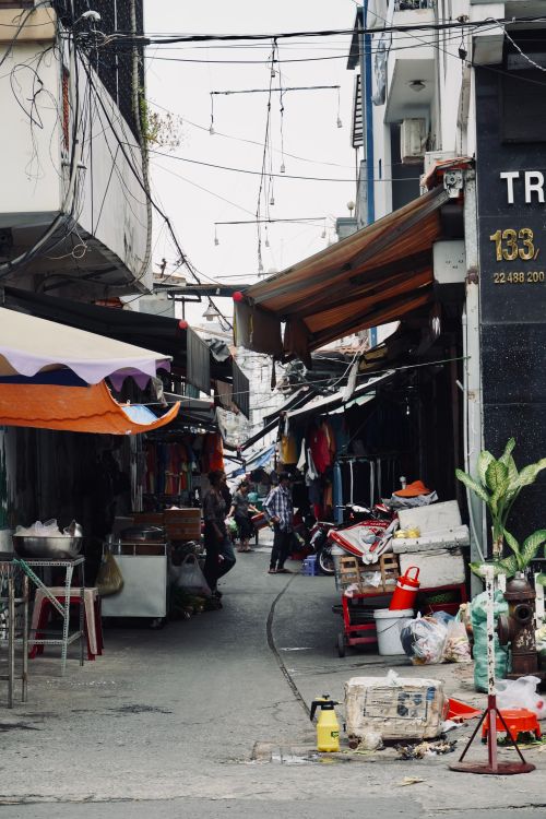 Free A vibrant alley market street capturing daily life with stalls and people. Stock Photo