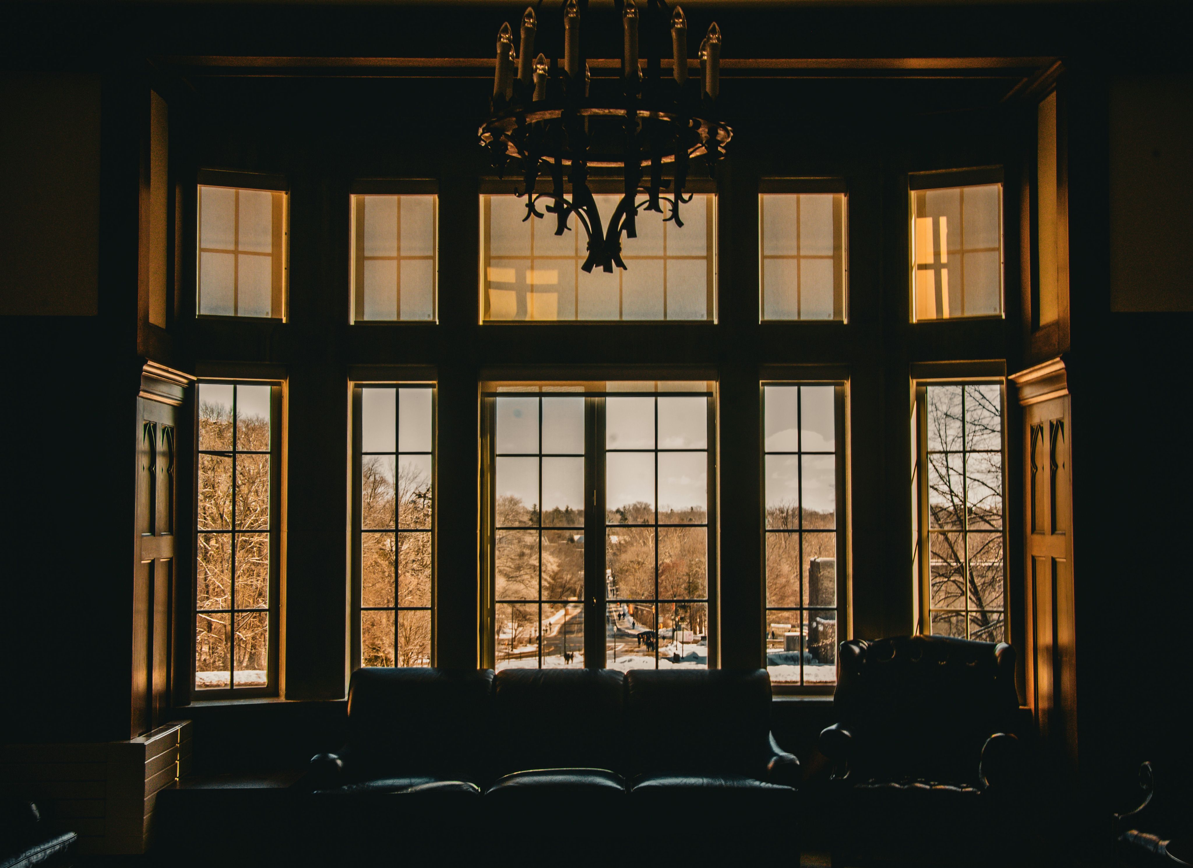 Warm interior with large windows overlooking a scenic outdoor view.