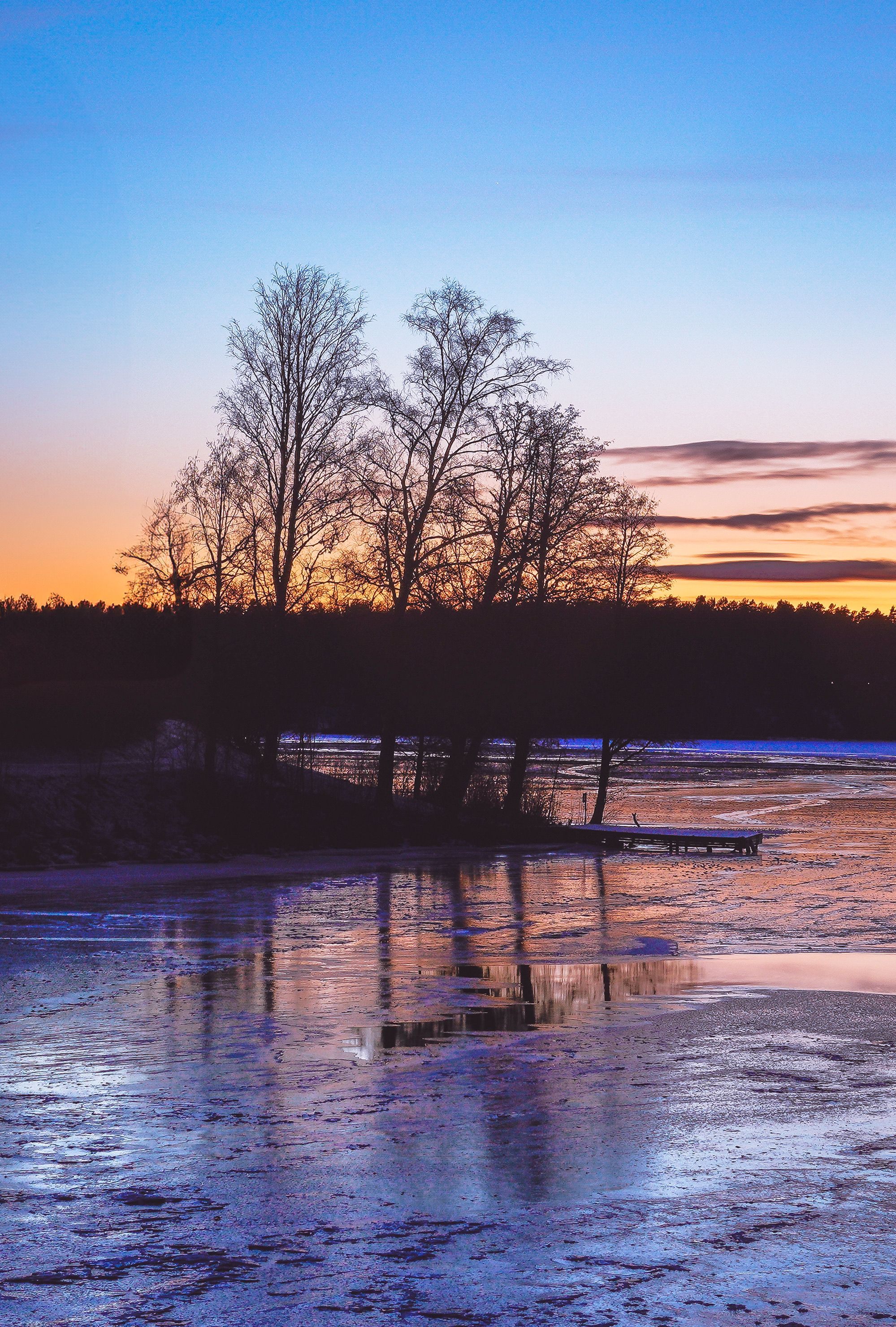 Serene Winter Sunset Over Frozen Lake · Free Stock Photo