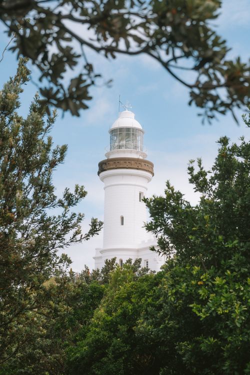 Free A view of Cape Byron Lighthouse surrounded by lush greenery in Byron Bay, Australia. Stock Photo