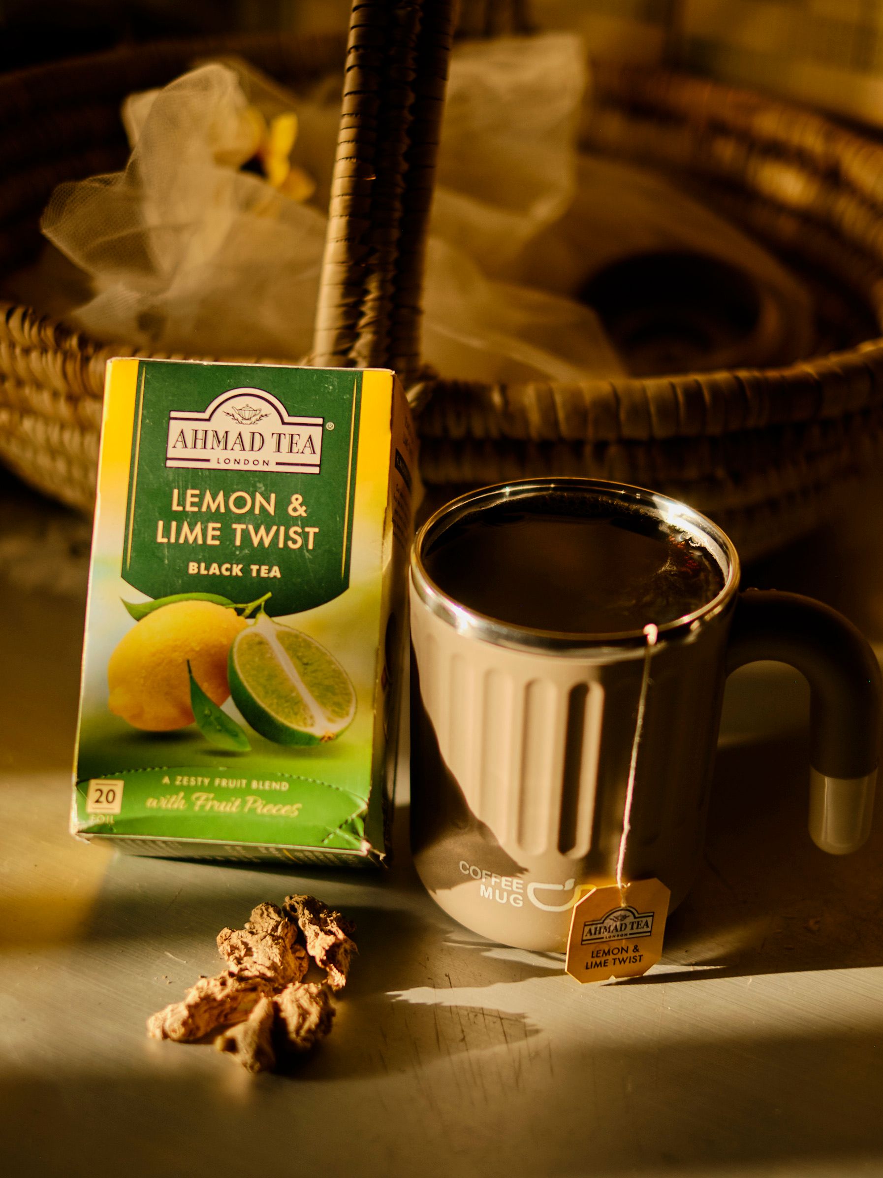 Tea box and mug with lemon and lime twist flavor captured in warm indoor light.