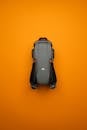 Sleek Gray Drone on Vibrant Orange Background